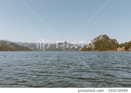 Scenic mountain landscape and calm water at Lake Skadar near Virpazar, Montenegro Scenic mountain landscape and calm water at Lake Skadar near Virpazar, Montenegro 140216986