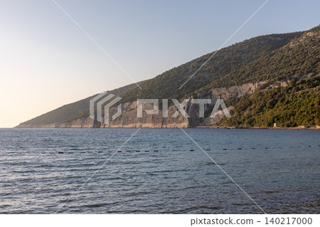 Adriatic Sea coastline with limestone cliffs and forested hills in Montenegro Adriatic Sea coastline with limestone cliffs and forested hills in Montenegro 140217000