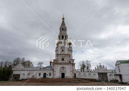 Nevyansk leaning tower and historic Orthodox church complex under cloudy sky 140217047