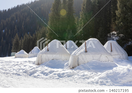 Snow covered yurts in Jeti-Oguz Gorge winter landscape with pine forest Snow covered yurts in Jeti-Oguz Gorge winter landscape with pine forest 140217195