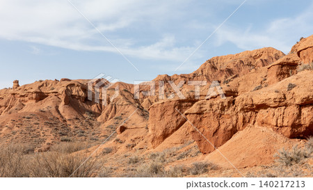 Mars Canyon red sandstone cliffs and eroded desert landscape in Kyrgyzstan Mars Canyon red sandstone cliffs and eroded desert landscape in Kyrgyzstan 140217213