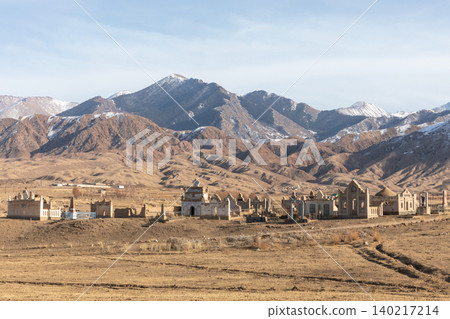 Rural cemetery and mausoleums in Kyrgyzstan with snowy Tian Shan mountains Rural cemetery and mausoleums in Kyrgyzstan with snowy Tian Shan mountains 140217214