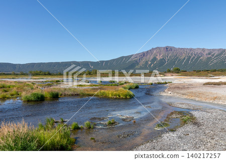 Uzon caldera geothermal valley with steaming springs and volcanic mountains Uzon caldera geothermal valley with steaming springs and volcanic mountains 140217257