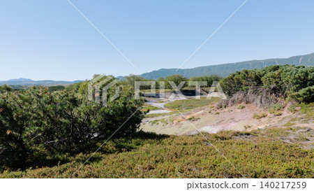 Uzon Volcano caldera landscape with tundra vegetation and distant mountains Uzon Volcano caldera landscape with tundra vegetation and distant mountains 140217259