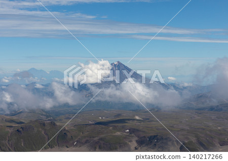 Volcanic mountain landscape with clouds over Kamchatka peninsula wilderness Volcanic mountain landscape with clouds over Kamchatka peninsula wilderness 140217266