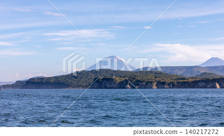 Volcanic coastline and sea view with distant volcanoes in Kamchatka Peninsula Volcanic coastline and sea view with distant volcanoes in Kamchatka Peninsula 140217272