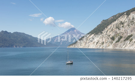 Vilyuchinskaya Bay seascape with sailboat and distant volcano, K Vilyuchinskaya Bay seascape with sailboat and distant volcano, K 140217295