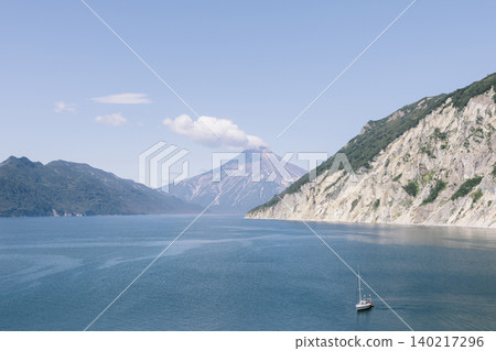Scenic Avacha Bay seascape with volcano and sailboat, Kamchatka Scenic Avacha Bay seascape with volcano and sailboat, Kamchatka 140217296