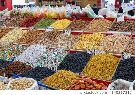 Colorful dried fruits, nuts and sweets at Osh Bazaar market stall in Bishkek 140217312