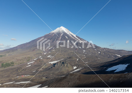 Koryaksky volcano with snow-capped summit under clear blue sky, Kamchatka Koryaksky volcano with snow-capped summit under clear blue sky, Kamchatka 140217354