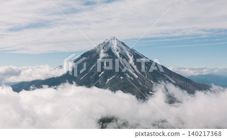 Koryaksky volcano summit rising above clouds in Kamchatka aerial landscape Koryaksky volcano summit rising above clouds in Kamchatka aerial landscape 140217368