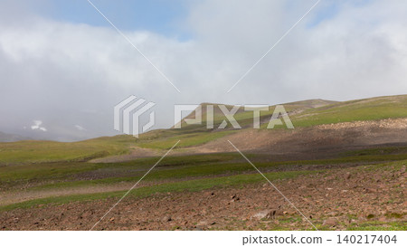 Misty tundra hills and volcanic landscape in Kamchatka wilderness, Russia 140217404