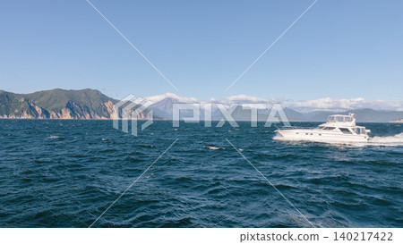 Motor yacht cruising on Avacha Bay seascape near Petropavlovsk-Kamchatsky Motor yacht cruising on Avacha Bay seascape near Petropavlovsk-Kamchatsky 140217422