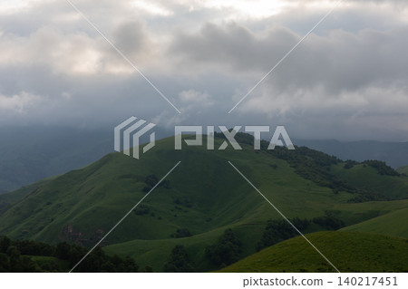 Misty green hills and dramatic storm clouds over Aktoprak mountain valley Misty green hills and dramatic storm clouds over Aktoprak mountain valley 140217451