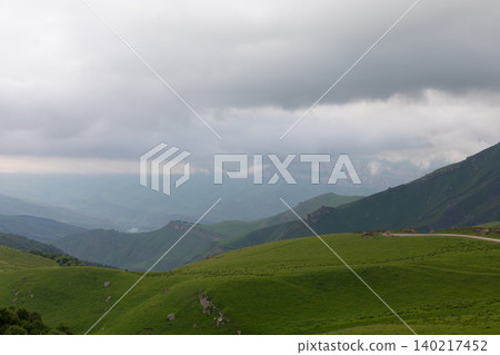 Cloudy mountain landscape near Aktoprak village with green hills, Caucasus Cloudy mountain landscape near Aktoprak village with green hills, Caucasus 140217452