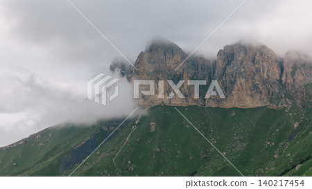 Foggy rocky mountain ridge above Aktoprak village in the Caucasus highlands Foggy rocky mountain ridge above Aktoprak village in the Caucasus highlands 140217454