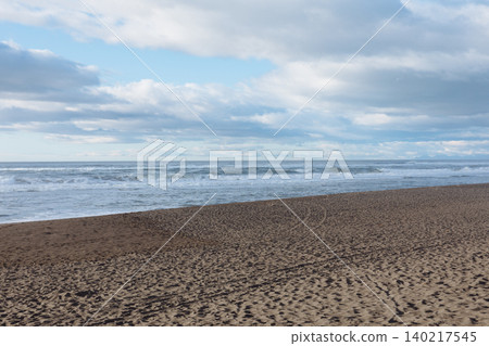 Khalaktyrsky Beach coastline with dark volcanic sand and cloudy sky panorama 140217545