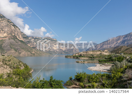 Mountain landscape at Irganay Reservoir with calm water and rocky canyon view Mountain landscape at Irganay Reservoir with calm water and rocky canyon view 140217564