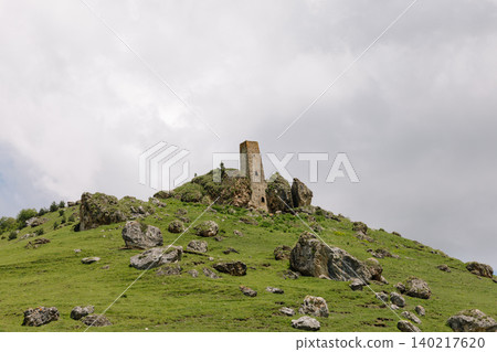 Medieval Khiani tower complex ruins on green mountain ridge under cloudy sky Medieval Khiani tower complex ruins on green mountain ridge under cloudy sky 140217620