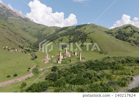 Aerial view of Targim tower complex ruins in a green mountain valley landscape Aerial view of Targim tower complex ruins in a green mountain valley landscape 140217624