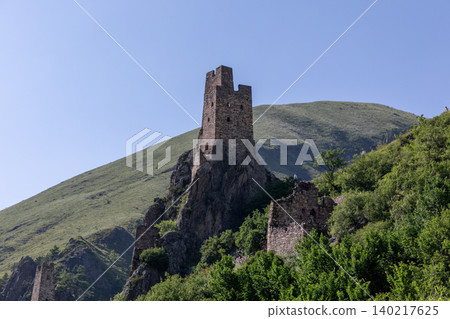 Vovnushki medieval stone tower complex on a rocky ridge in the Caucasus Vovnushki medieval stone tower complex on a rocky ridge in the Caucasus 140217625