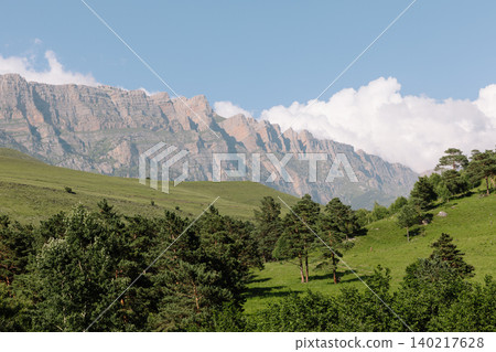Mountain ridge and green alpine meadow landscape in Ingushetia, Caucasus region Mountain ridge and green alpine meadow landscape in Ingushetia, Caucasus region 140217628