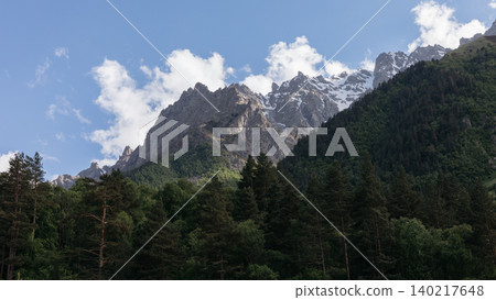 Mountain landscape with forest and snowy peaks in Ingushetia, Caucasus region Mountain landscape with forest and snowy peaks in Ingushetia, Caucasus region 140217648