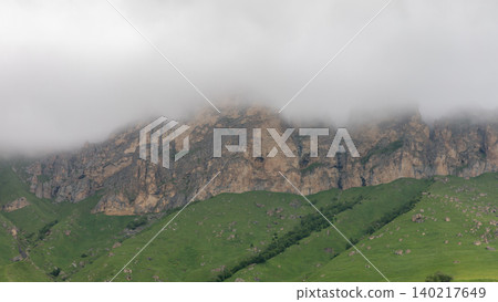 Foggy rocky cliffs above green hills in Aktoprak mountain valley landscape Foggy rocky cliffs above green hills in Aktoprak mountain valley landscape 140217649