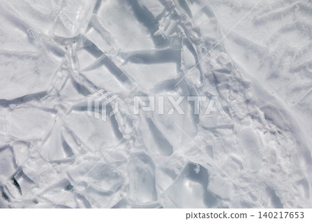 Cracked ice texture on Lake Baikal in winter, natural frozen water background Cracked ice texture on Lake Baikal in winter, natural frozen water background 140217653