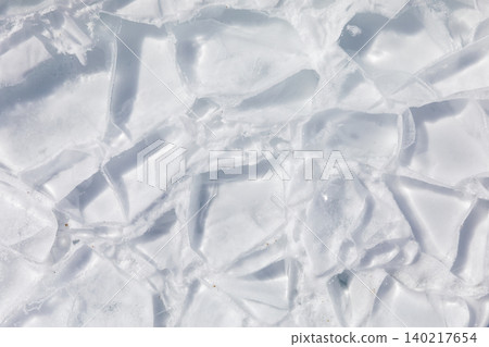 Cracked lake ice texture on Lake Baikal, abstract winter background pattern Cracked lake ice texture on Lake Baikal, abstract winter background pattern 140217654