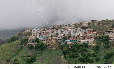 Mountain village of Chokh on green hillside under low clouds in Dagestan 140217736
