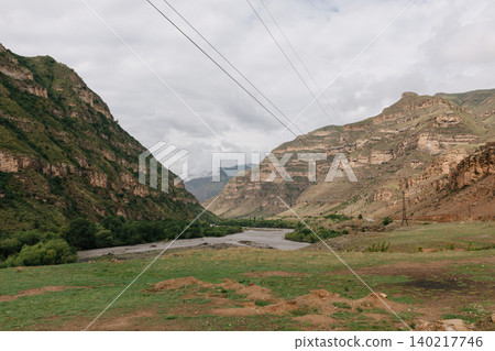 Mountain river valley landscape with power lines in Dagestan, Caucasus region Mountain river valley landscape with power lines in Dagestan, Caucasus region 140217746