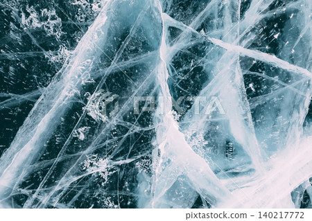 Abstract cracked ice texture on Lake Baikal surface in winter, close up background Abstract cracked ice texture on Lake Baikal surface in winter, close up background 140217772