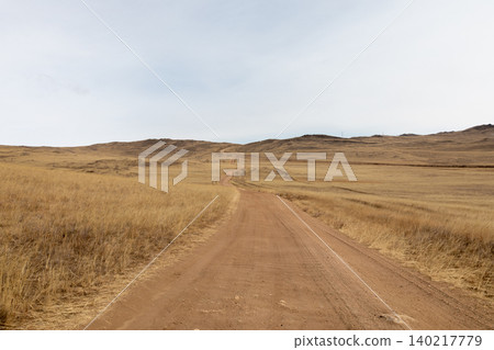 Empty dirt road through steppe landscape on Olkhon Island near Lake Baikal Empty dirt road through steppe landscape on Olkhon Island near Lake Baikal 140217779