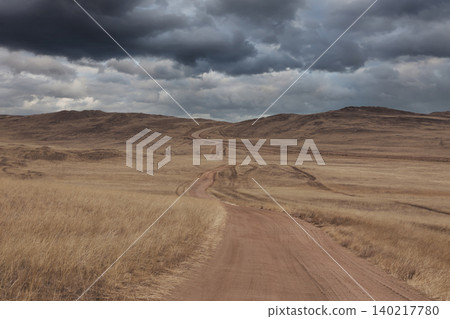 Winding dirt road through steppe hills on Olkhon Island near Lake Baikal Winding dirt road through steppe hills on Olkhon Island near Lake Baikal 140217780