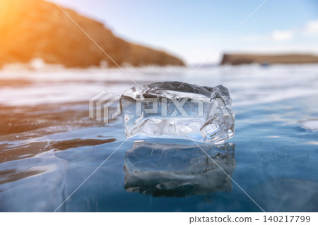 Clear ice block on frozen Lake Baikal with winter landscape and copy space Clear ice block on frozen Lake Baikal with winter landscape and copy space 140217799