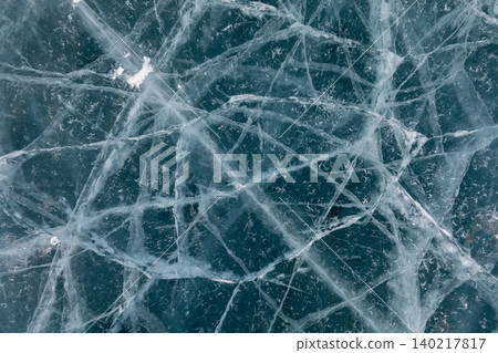 Abstract cracked ice texture background with blue frozen lake surface close up Abstract cracked ice texture background with blue frozen lake surface close up 140217817