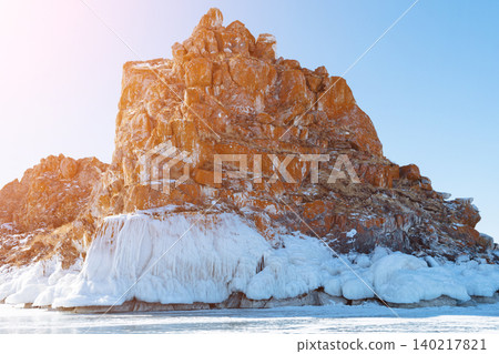 Shaman Rock Shamanka on frozen Lake Baikal coast in winter sunlight 140217821