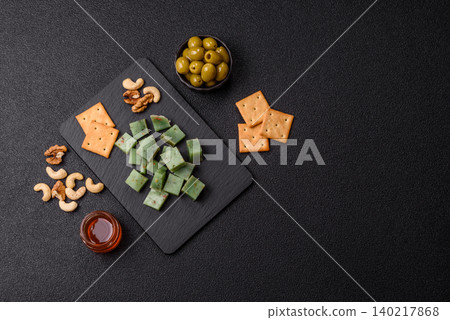 Hard green pesto cheese with herbs as a pasta ingredient. Green pesto cheese Hard green pesto cheese with herbs as a pasta ingredient. Green pesto cheese 140217868