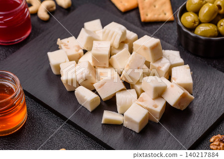 White feta, tofu, or mozzarella cheese cubes with herbs. White mozzarella cheese White feta, tofu, or mozzarella cheese cubes with herbs. White mozzarella cheese 140217884