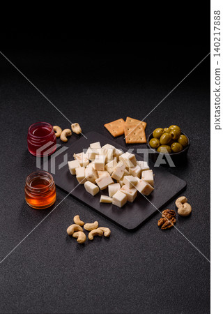 White feta, tofu, or mozzarella cheese cubes with herbs. White mozzarella cheese 140217888