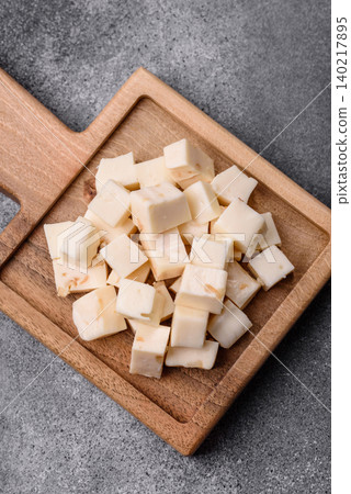 White feta, tofu, or mozzarella cheese cubes with herbs. White mozzarella cheese White feta, tofu, or mozzarella cheese cubes with herbs. White mozzarella cheese 140217895