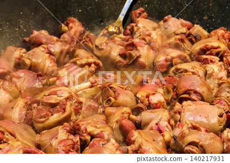 Cooking of pork knuckle (traditional german dish) in big cauldron 140217931