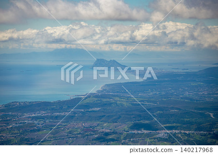 Sweeping mountain panorama revealing the sparkling Mediterranean Sea, Estepona and distant Gibraltar beneath open skies from Sierra Bermeja in Spain. Sweeping mountain panorama revealing the sparkling Mediterranean Sea, Estepona and distant Gibraltar beneath open skies from Sierra Bermeja in Spain. 140217968