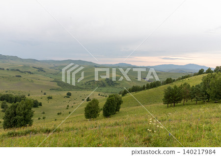 Panoramic view from Chertov Palets mountain over green Altai hills at sunset Panoramic view from Chertov Palets mountain over green Altai hills at sunset 140217984
