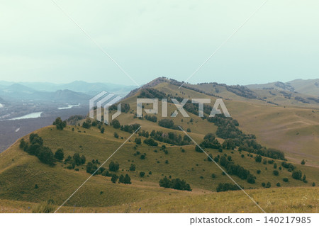 Devil's Finger Mountain ridge with rolling hills and forest, Altai landscape view 140217985