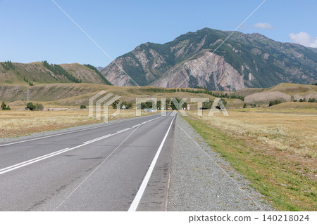 Scenic highway through Altai Mountains valley with rocky peaks and open steppe Scenic highway through Altai Mountains valley with rocky peaks and open steppe 140218024
