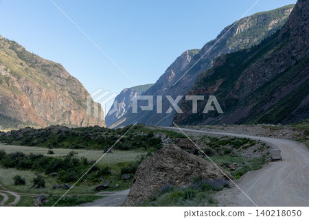 Scenic dirt road through Chulyshman Valley between rocky mountains, Altai Scenic dirt road through Chulyshman Valley between rocky mountains, Altai 140218050