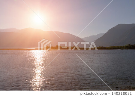 Sunset over Teletskoye Lake with mountain silhouettes and calm water, Altai Sunset over Teletskoye Lake with mountain silhouettes and calm water, Altai 140218051