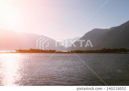 Sunset over Teletskoye Lake with mountain silhouettes and calm water, Altai Sunset over Teletskoye Lake with mountain silhouettes and calm water, Altai 140218052